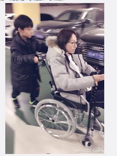白百何受伤坐轮椅外出 儿子在其身后卖力推(图